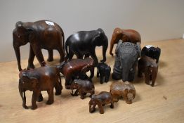 An assorted collection of hardwood and other elephant studies, including a clay art pottery study