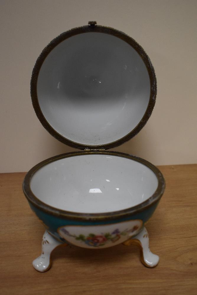 A Continental porcelain footed egg trinket box, decorated with vignettes of floral arrangements - Image 2 of 2