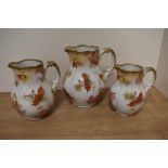 A trio of Royal stafforshire semi porcelain 'Scarbro' graduated jugs, having white ground with