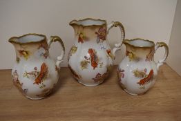 A trio of Royal stafforshire semi porcelain 'Scarbro' graduated jugs, having white ground with