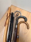 A selection of walking sticks, to include a stick with bone handle and silver hallmarked collar, and