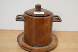 A 1930s treen tobacco jar, having integrated pipe holders to sides and ceramic liner.