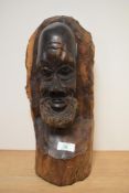 An African carved hardwood bust, depicting gent with beard.