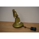 A vintage brass wall mounted bell.