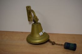 A vintage brass wall mounted bell.