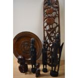 An African hardwood carved wall plaque, of bowed form, decorated with animals including a lion,