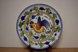 A continental platter, having cockerel depicted to centre with foliate border.
