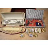An assorted collection of vintage costume jewellery, to include enamelled metal pill boxes,