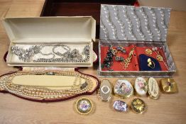 An assorted collection of vintage costume jewellery, to include enamelled metal pill boxes,