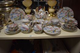 A selection of Japanese tea cups, saucers, tea pot, sugar basin and plates, having traditional