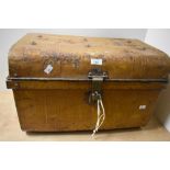 An early 20th Century brown painted tin trunk of domed form, measuring 36cm x 56cm x 34cm overall