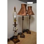 A pair of 20th Century French style table lamps, having copper coloured lamp shades, measuring