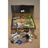 A collection of vintage costume jewellery, including brooches and scarf rings.