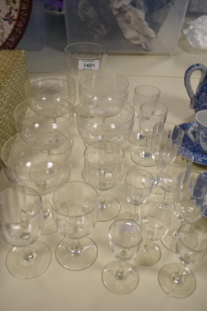 A collection of antique glasses, including etched and wine glasses and tumbler with etched logo; '