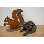A cast metal door stop in the form of a frog and a patinated metal squirrel.