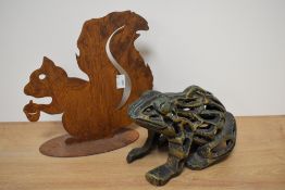 A cast metal door stop in the form of a frog and a patinated metal squirrel.