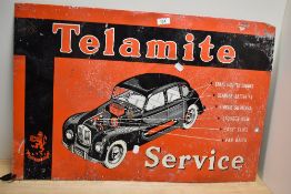 A vintage Telamite Service tin advertising sign painted in red, white, and black, measuring 49cm x
