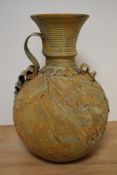 A studio pottery vase, having rustic finish, of bulbous form with handle to side, approx 36cm high.