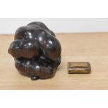 A carved hardwood weeping Buddha and an antique treen snuff box.