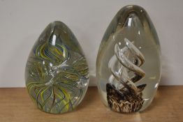 Two glass paperweights, one having colourful multi spiral twists, the other with air twists and