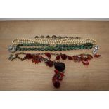 A selection of costume jewellery, including beads and brooches.