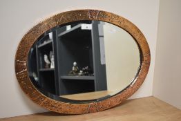 A circa 1900 Arts and Crafts hammered copper framed mirror with original bevelled glass.