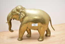 A vintage brass elephant, approx 21cm high by 30cm long.