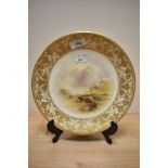 A hand painted Royal Worcester plate, circa 1916, having Highland cattle and mountain scene depicted