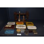 A selection of vintage tobacco and snuff tins, three vesta cases and a pipe rack with four vintage