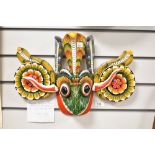 An eye catching and traditional Sri Lankan wooden mask, measuring 43cm wide