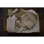 An assorted collection of soft goods and laced worked items, including table cloths and place mats