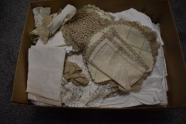 An assorted collection of soft goods and laced worked items, including table cloths and place mats