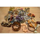 A large assortment of costume bracelets including bangles, statement cuff bracelets, beaded examples
