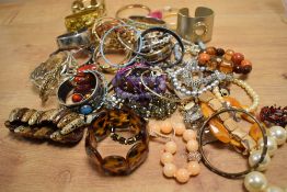 A large assortment of costume bracelets including bangles, statement cuff bracelets, beaded examples