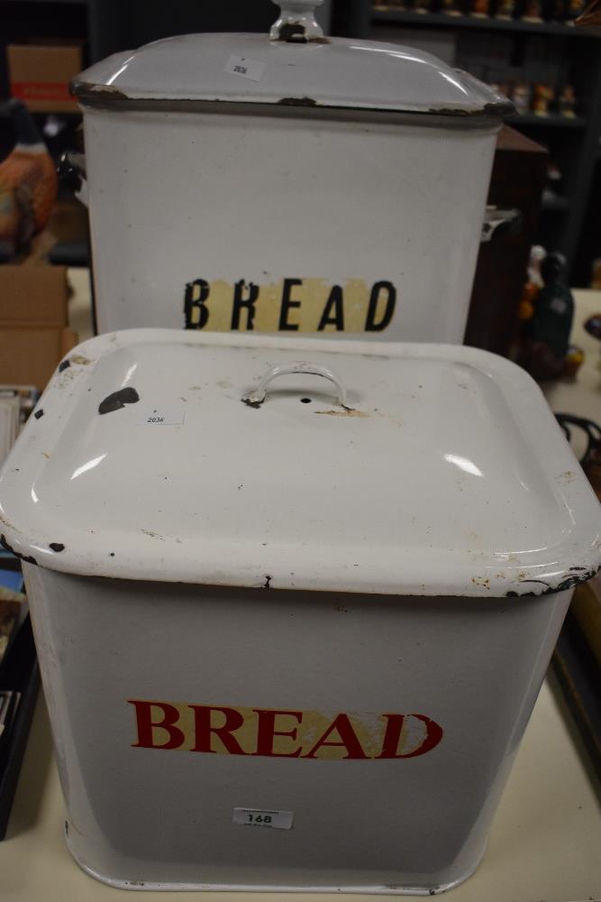Two mid-20th Century enamelled tin bread bins, each measuring 32cm high