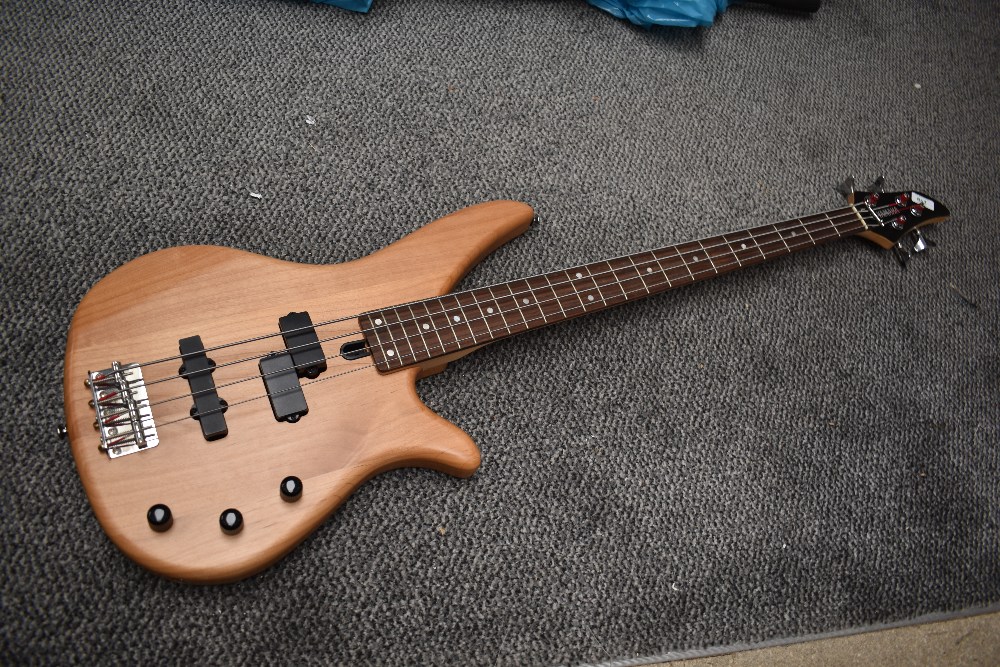 A Yamaha RBX270 bass guitar, having natural finish, serial number HY15056, with JHS vinyl gig bag