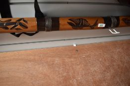 A traditional didgeridoo having animalistic decoration