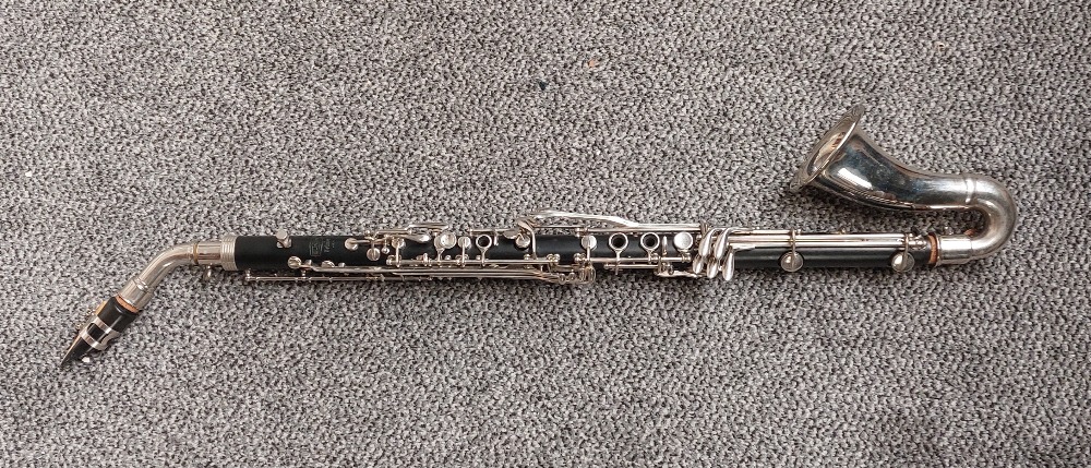 A Bundy by Selmer bass clarinet, with Vandoren Paris B44 mouthpiece, serial number 25736 with hard