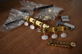 A small selection of guitar parts including machine heads, tunamatic bridge and tailpiece