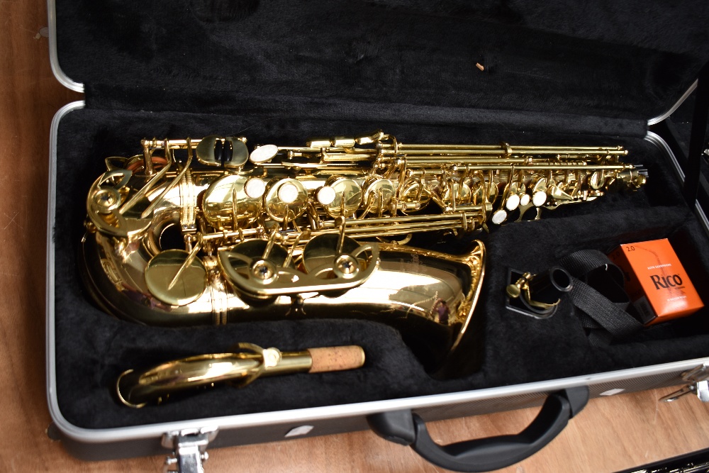 A Gear 4 Music alto saxophone AS-100G with unbranded mouthpiece and fitted case, serial number