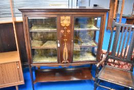 An Art Nouveau mahogany and inlaid display cabinet with shelf under
