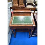 A Victorian mahogany davenport desk having raised back and turned supports