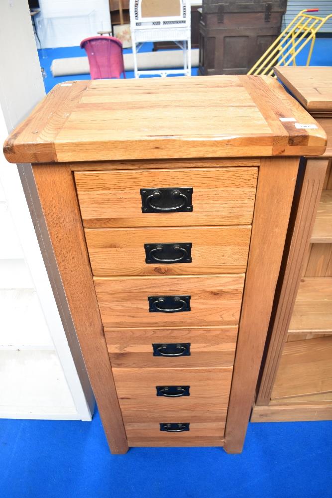 A modern oak tall bedroom chest