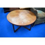 A vintage teak frame coffee table of circular top having feathered top