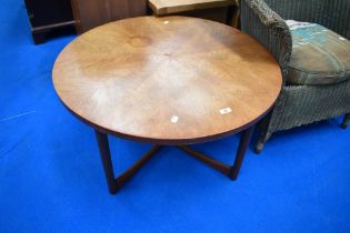 A vintage teak frame coffee table of circular top having feathered top