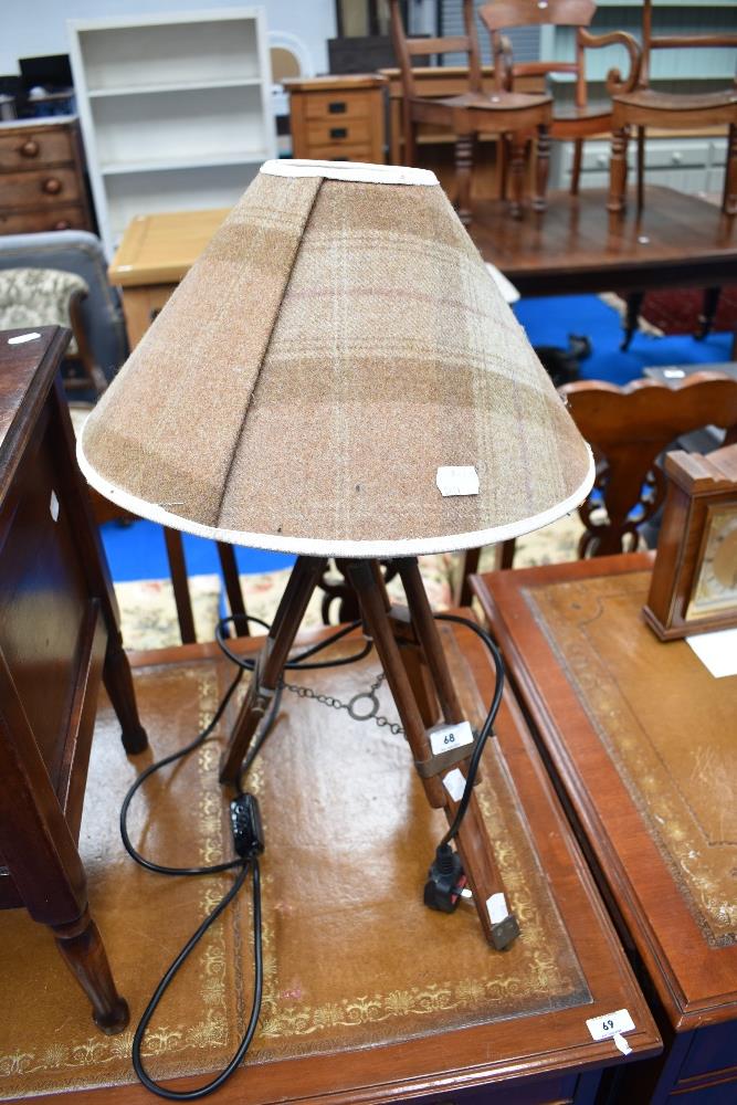 A reproduction table lamp having tripod extending legs