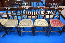 A harlequin set of four railback dining chairs, believed to be of local interest