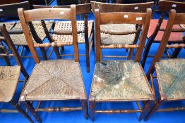 Five 19th Century rush seated chairs having turned rail backs, believed to be of local interest