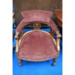 A Victorian salon style low easy chair on turned legs