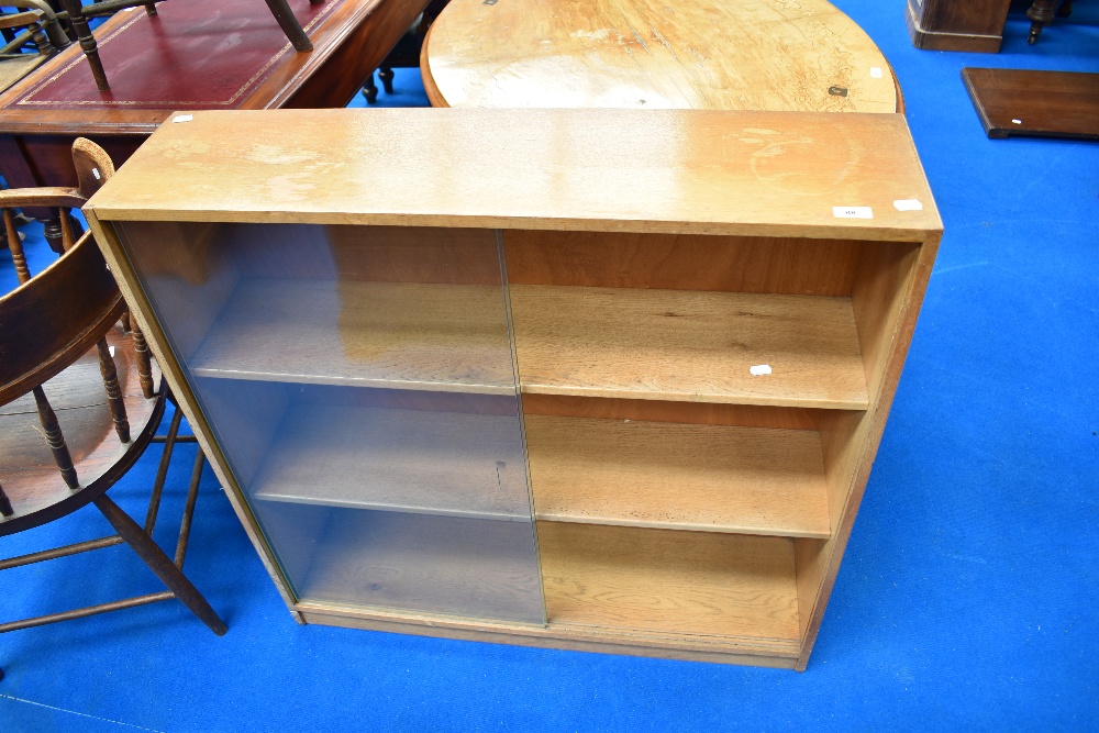 A vintage light oak low bookcase